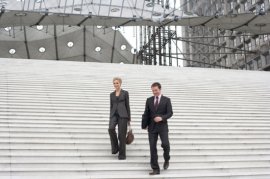 Two businesspeople outside decreasing staircase